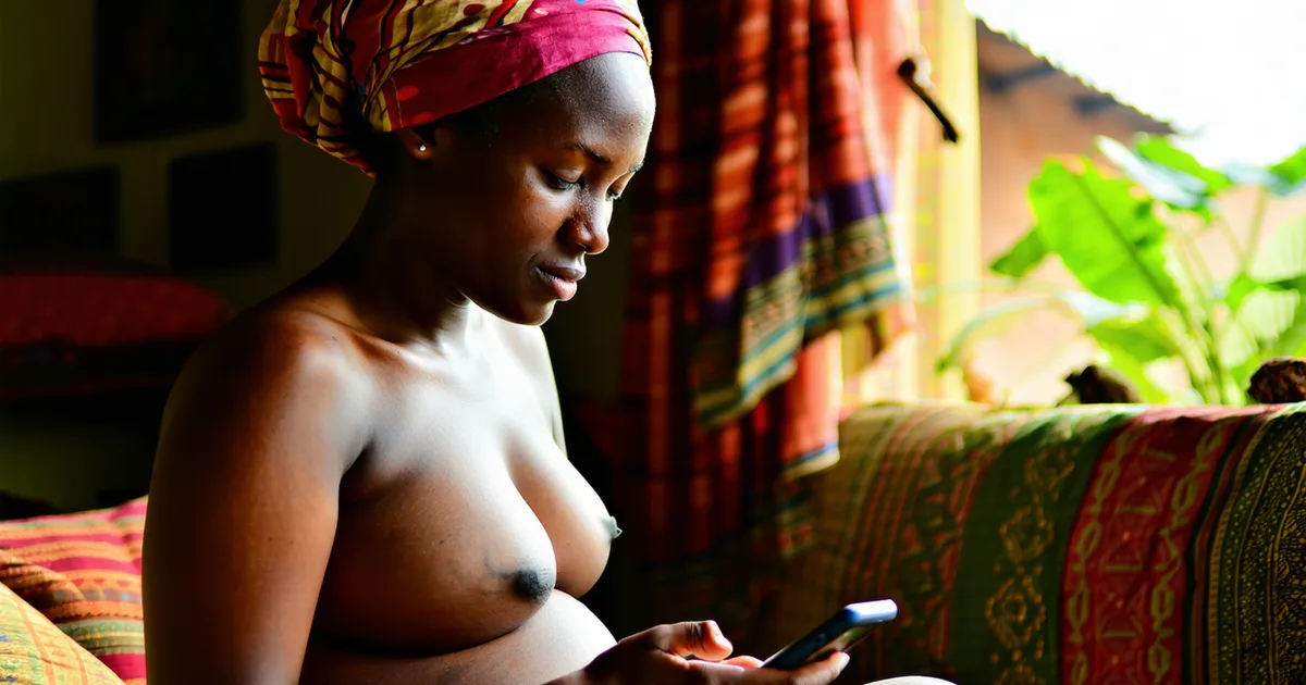 Pregnant East African woman using a smartphone at home